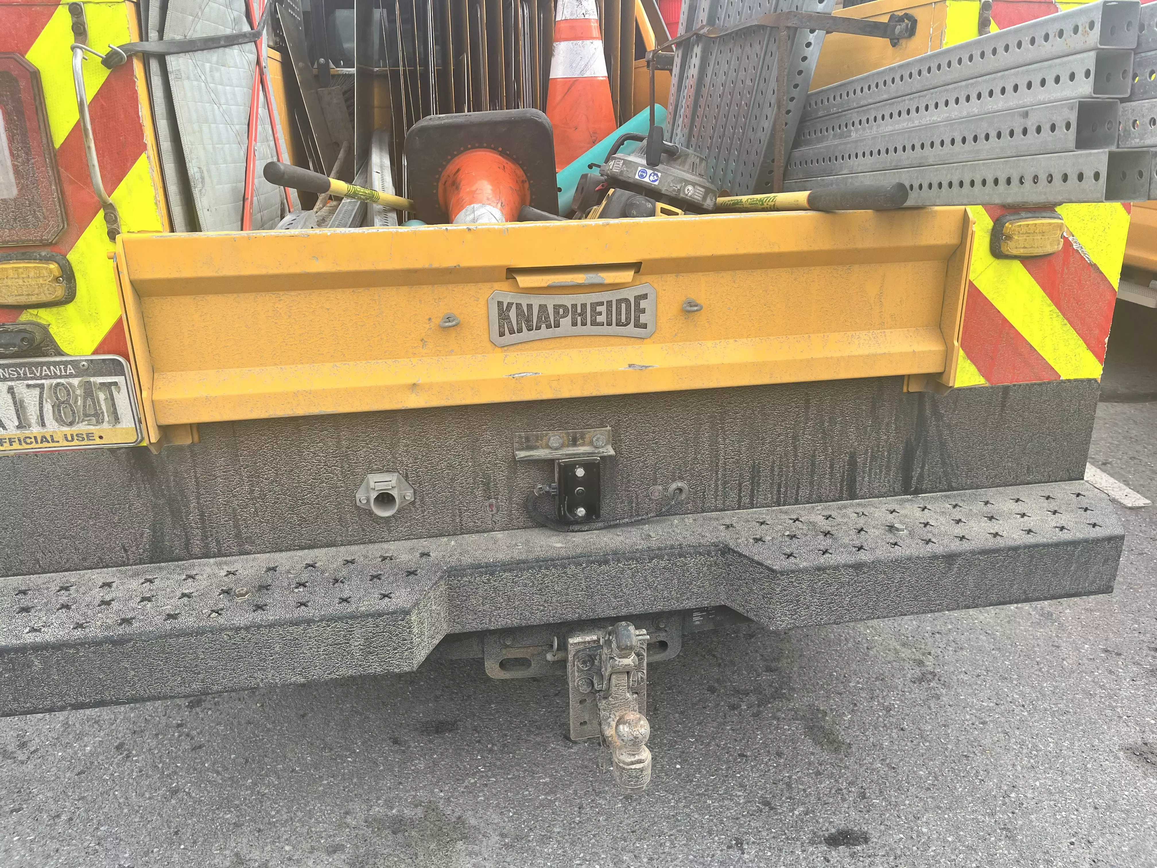 An image showing a rear view of a yellow PennDOT crew cab pickup truck with the new back-up camera attached above the truck's license plate.